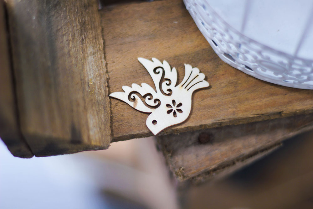 A stylized cutout of a dove on the edge of a table